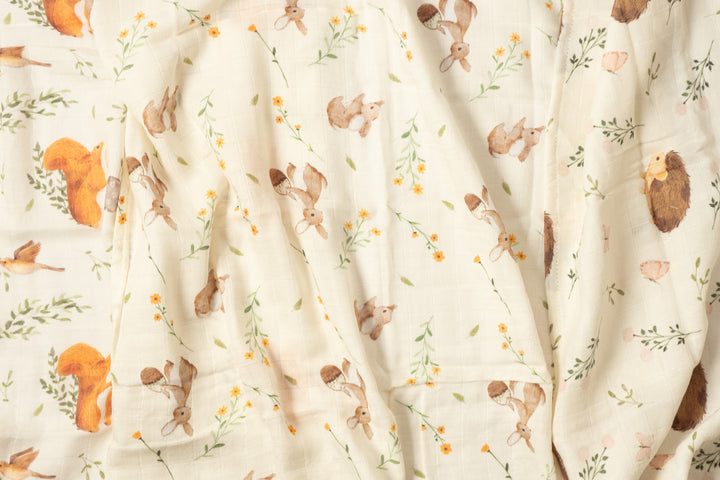 Close-up of bamboo muslin cloths in woodland animals print, unfolded to show the soft gauze texture